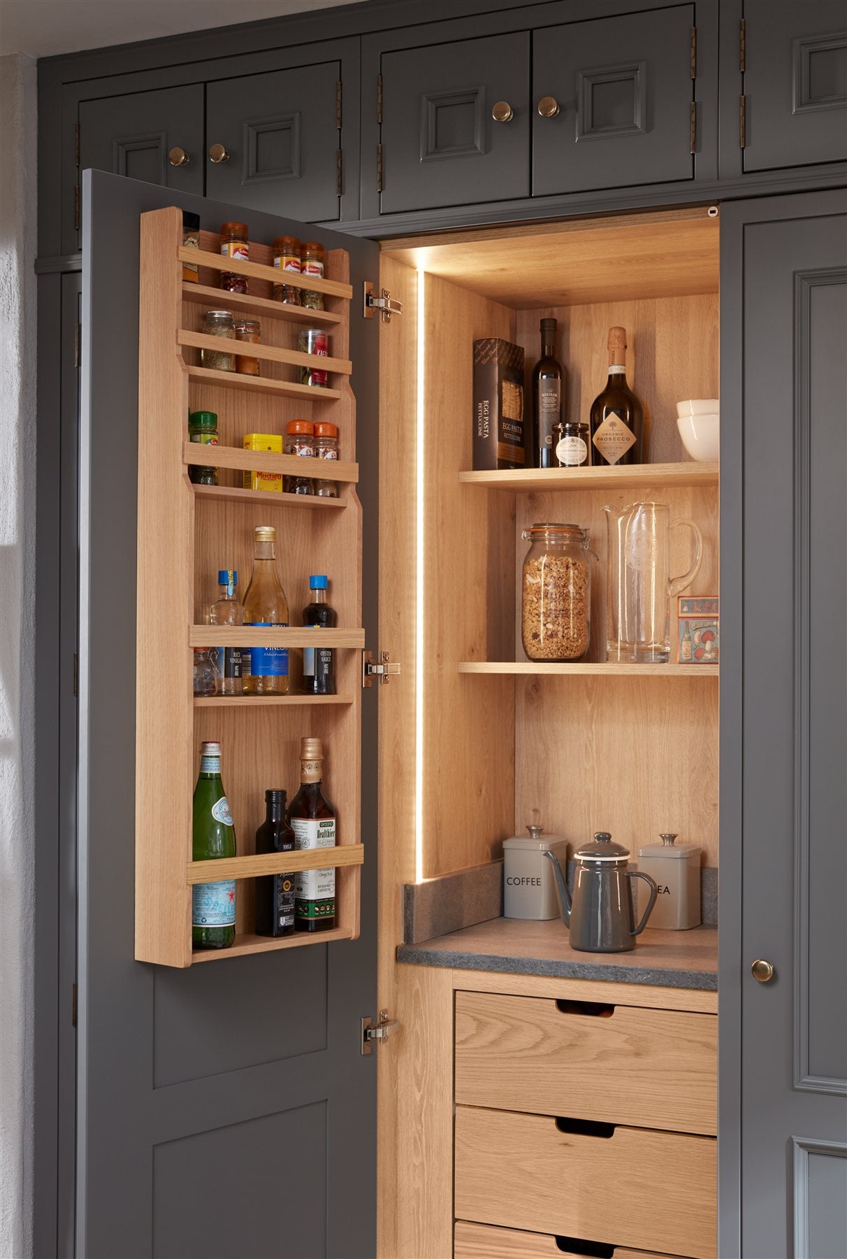 Interior inspiration: a dark painted pantry with timber shelves and door storage